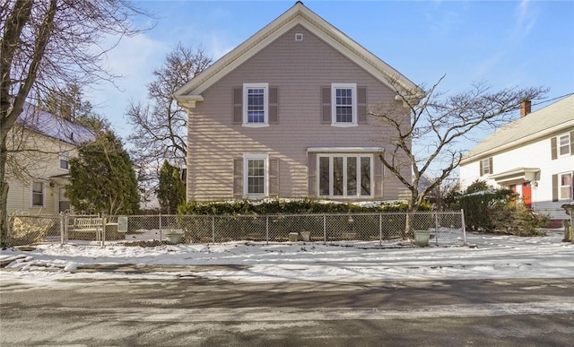 view of snow covered rear of property