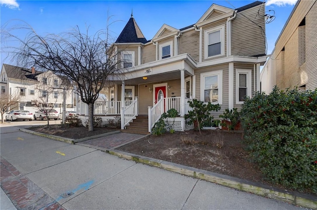 townhome / multi-family property with a porch