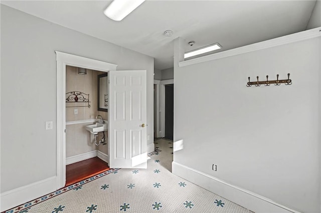 unfurnished bedroom with tile patterned flooring and sink