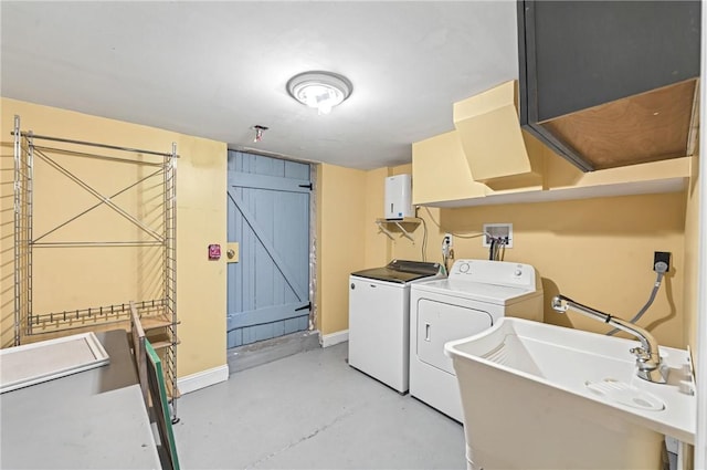 clothes washing area featuring separate washer and dryer and sink