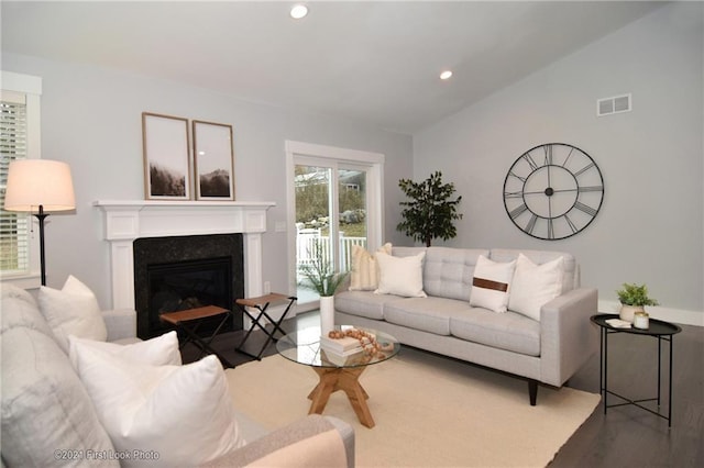 living room with lofted ceiling and hardwood / wood-style floors