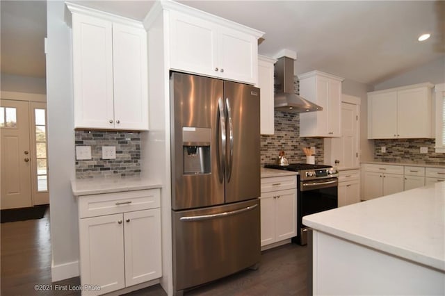 kitchen with backsplash, white cabinetry, stainless steel appliances, and wall chimney range hood