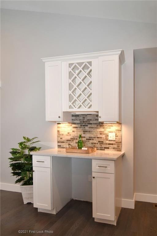 bar with lofted ceiling, white cabinets, dark hardwood / wood-style flooring, and decorative backsplash