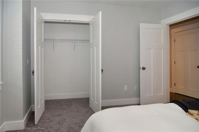 bedroom with light carpet and a closet