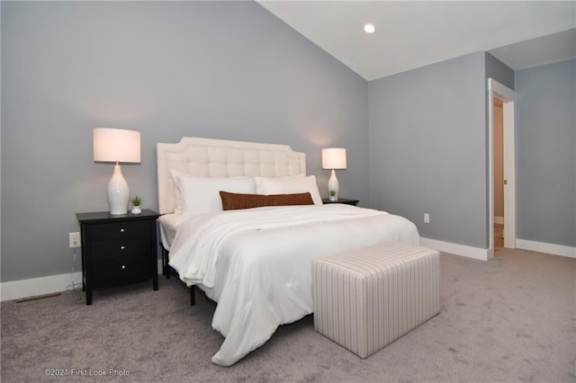 carpeted bedroom with lofted ceiling