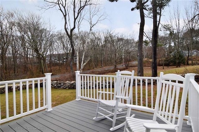 wooden deck with a lawn