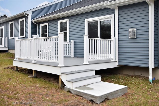 wooden deck featuring a lawn