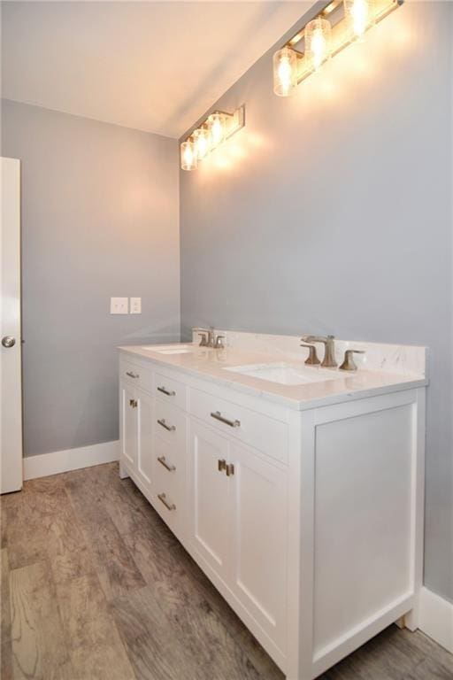 bathroom with vanity and wood-type flooring