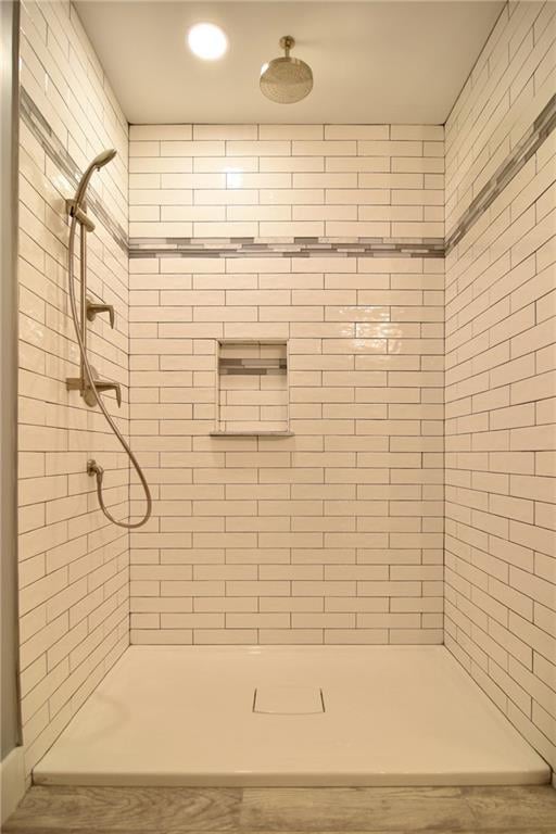 bathroom with tiled shower