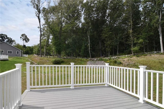 wooden terrace featuring a yard