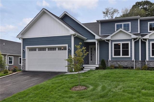 craftsman house with a garage and a front lawn