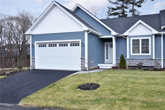 craftsman-style home with a garage and a front lawn