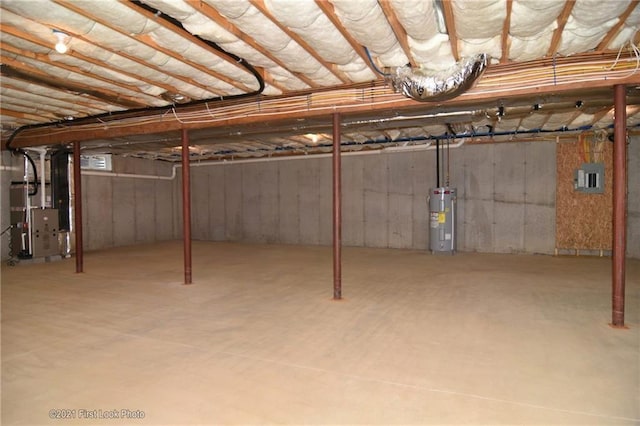 basement featuring heating unit and electric water heater