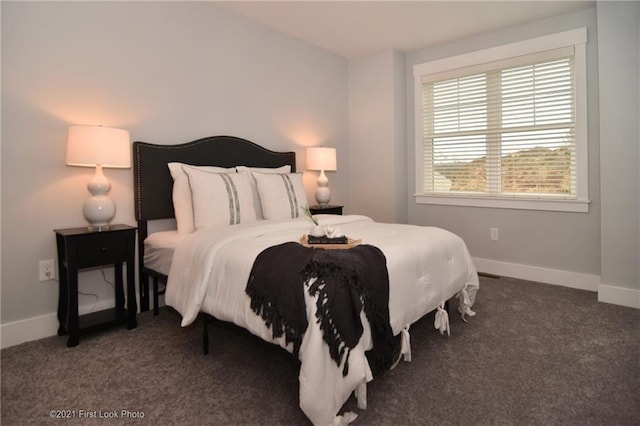 bedroom featuring dark colored carpet