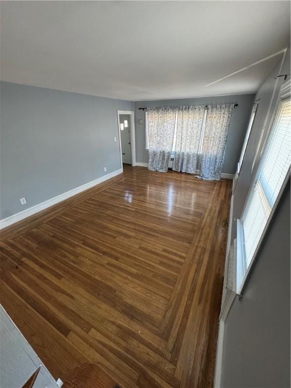 unfurnished living room with wood-type flooring