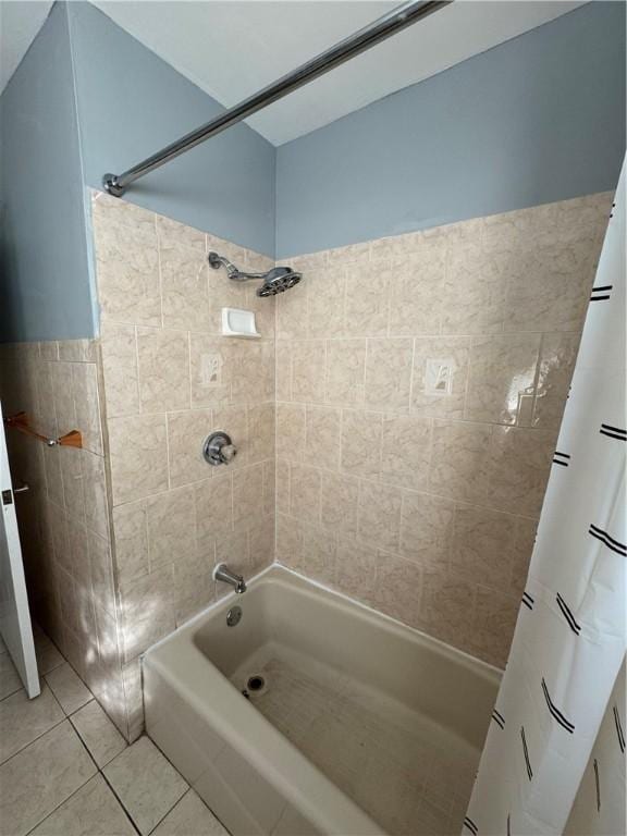 bathroom featuring tile patterned flooring and tiled shower / bath combo