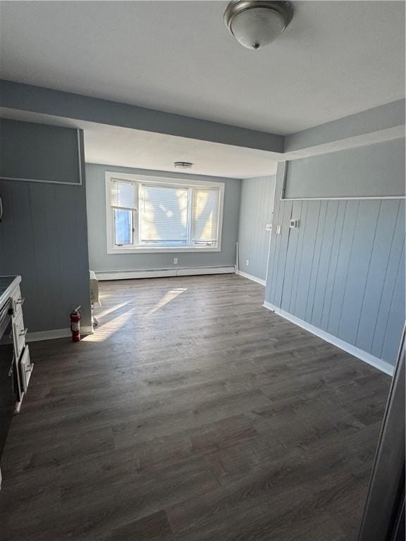 unfurnished living room with dark hardwood / wood-style floors and baseboard heating