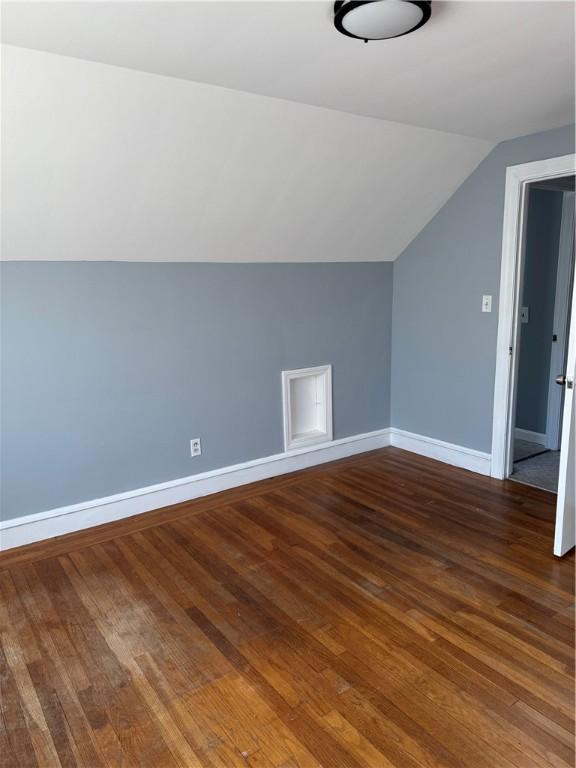 bonus room featuring lofted ceiling and dark wood-type flooring