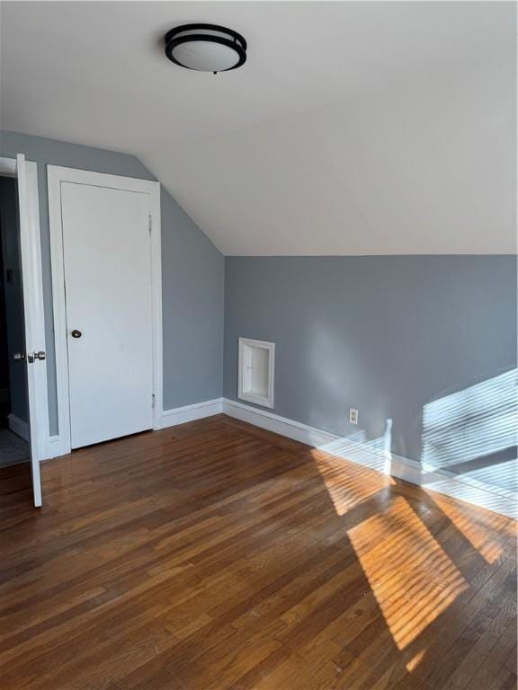 additional living space with lofted ceiling and dark hardwood / wood-style floors