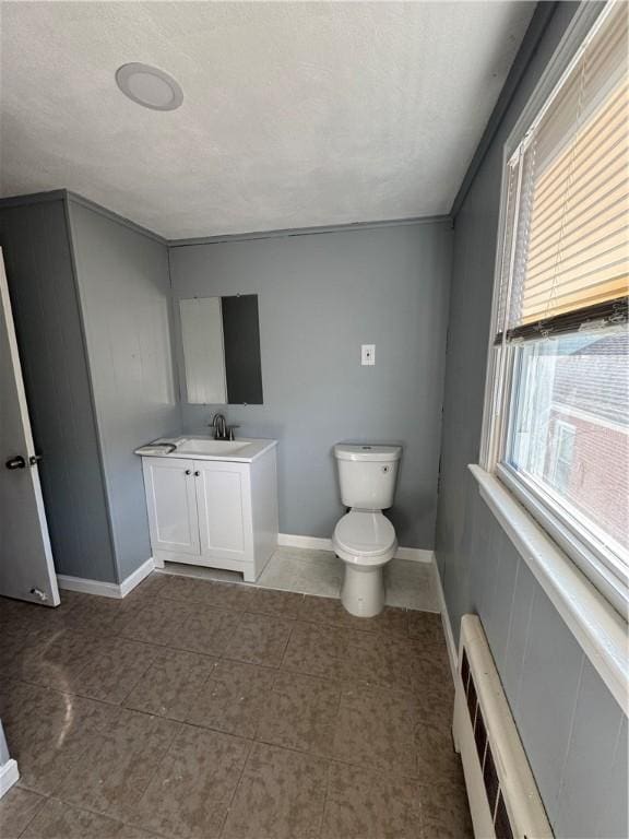 bathroom featuring vanity, radiator, and toilet