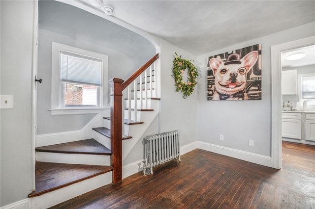 stairway with radiator heating unit and wood-type flooring