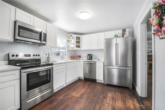 kitchen featuring white cabinetry, stainless steel appliances, dark hardwood / wood-style flooring, and sink