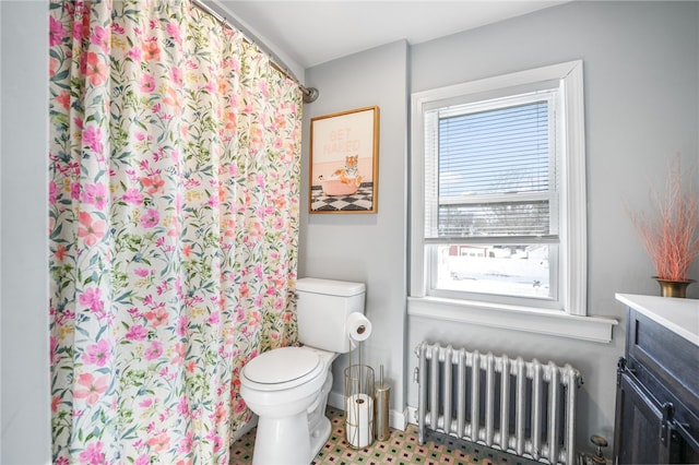 bathroom with vanity, curtained shower, radiator heating unit, and toilet