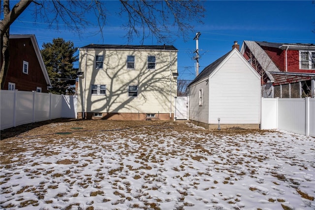 view of snow covered back of property