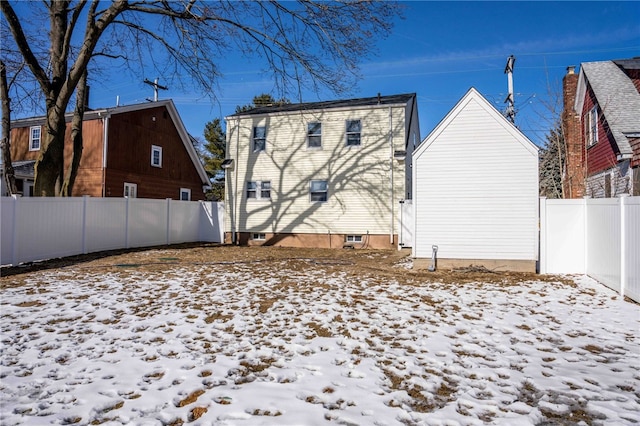 view of snow covered rear of property