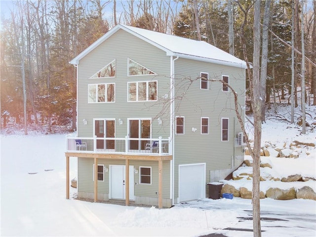 snow covered house with a balcony and a garage