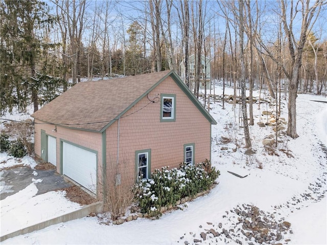 view of snow covered exterior with a garage