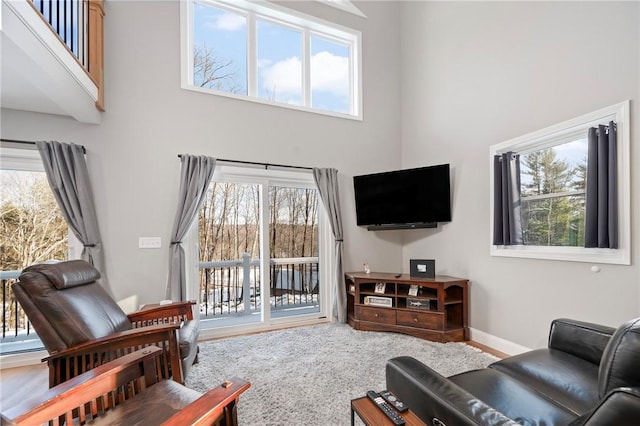 living room featuring a healthy amount of sunlight and a high ceiling