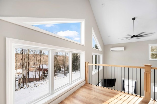 unfurnished sunroom with lofted ceiling, an AC wall unit, and ceiling fan