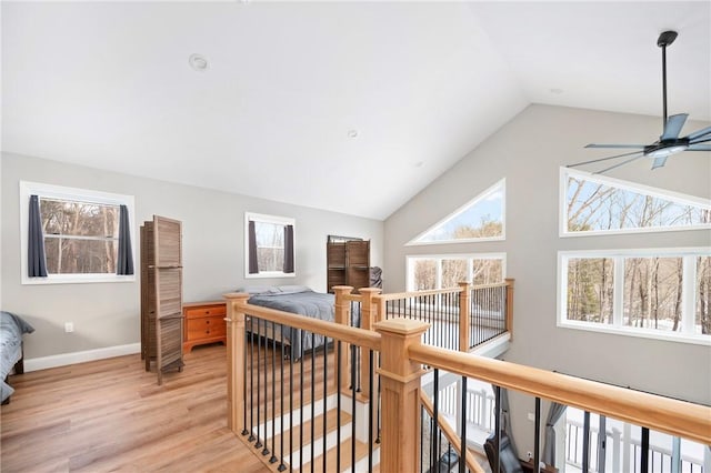 corridor featuring light hardwood / wood-style floors and vaulted ceiling