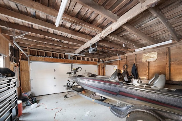 garage featuring a garage door opener and wooden ceiling