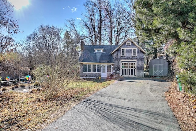 view of front of house featuring a storage shed