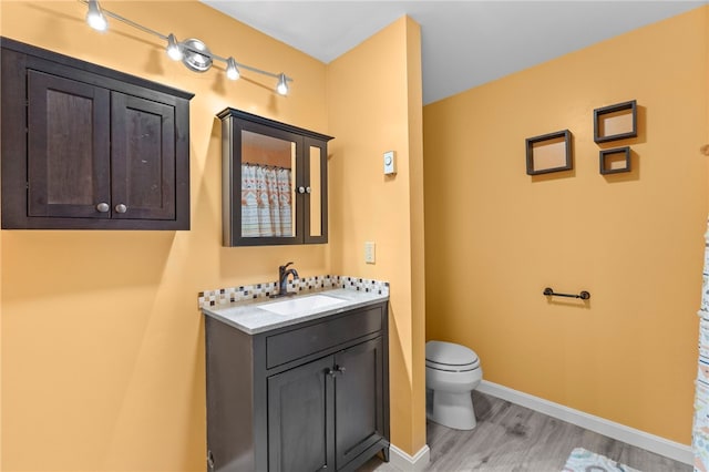 bathroom with vanity, hardwood / wood-style floors, and toilet