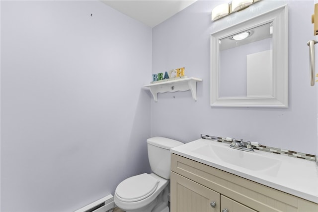 bathroom with vanity, baseboard heating, and toilet