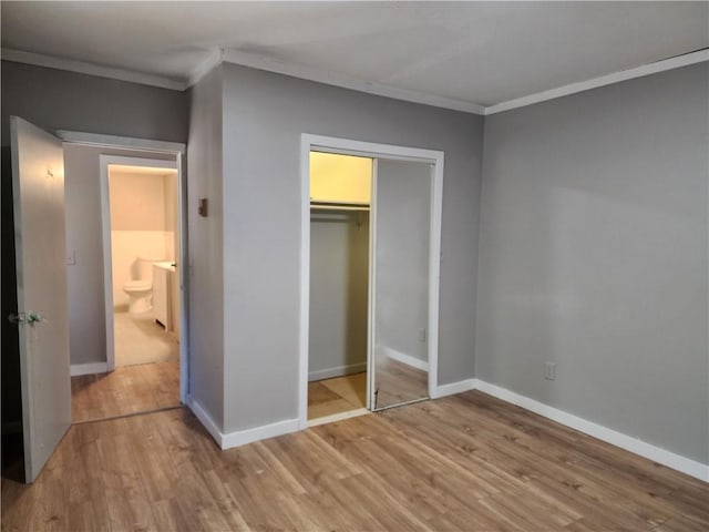 unfurnished bedroom with ornamental molding and light hardwood / wood-style floors