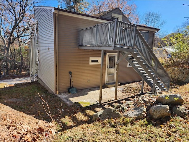 back of house with a wooden deck