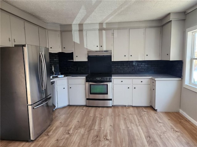 kitchen featuring a healthy amount of sunlight, stainless steel appliances, and white cabinets