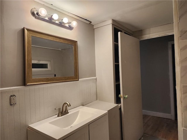 bathroom featuring vanity, wood-type flooring, and wood walls