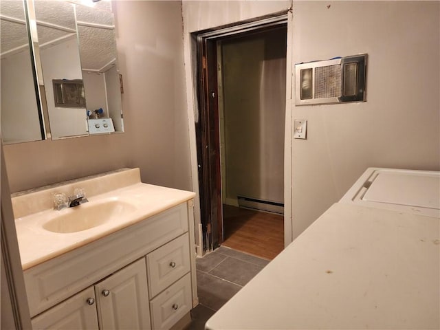 bathroom with tile patterned floors, a wall mounted air conditioner, a textured ceiling, a baseboard radiator, and vanity