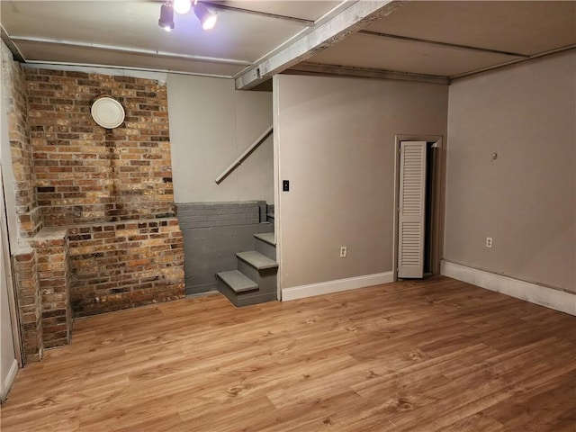 basement with light hardwood / wood-style floors