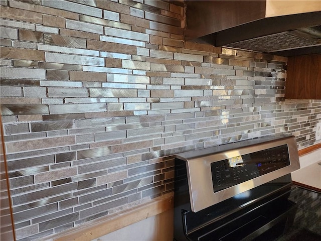 interior details with stainless steel electric stove and decorative backsplash