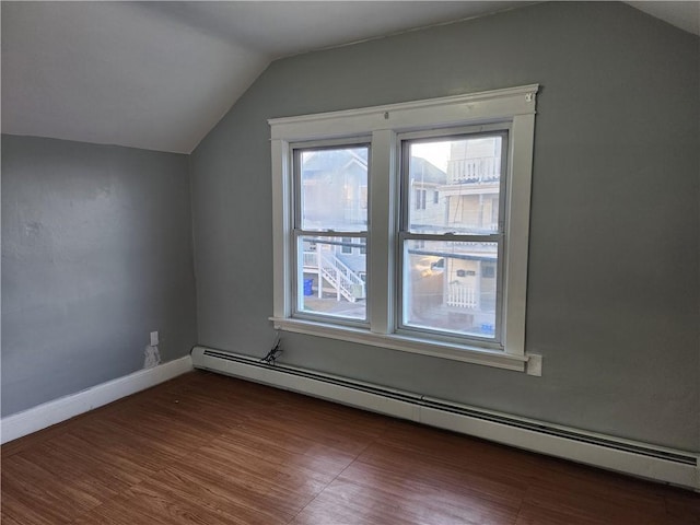 additional living space featuring lofted ceiling, a baseboard radiator, and dark hardwood / wood-style floors