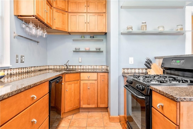 kitchen featuring light tile patterned flooring, sink, light stone counters, and black appliances