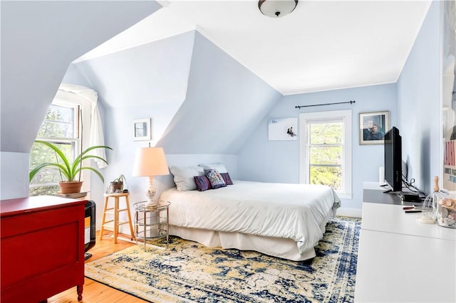 bedroom featuring lofted ceiling and wood-type flooring