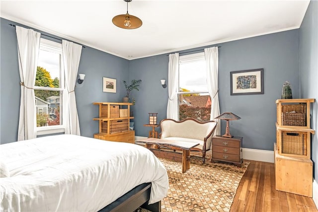 bedroom with hardwood / wood-style floors and multiple windows