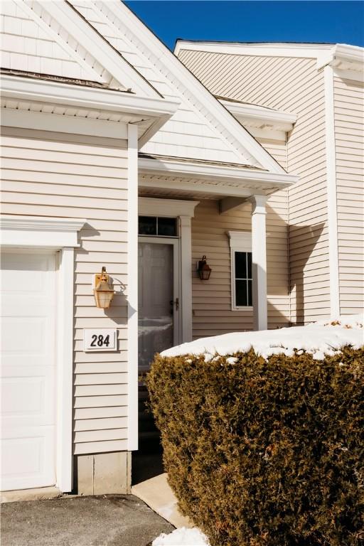 doorway to property with a garage